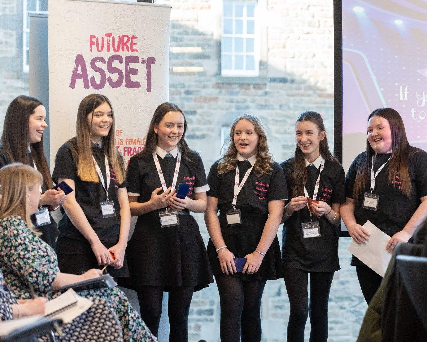 Six members of the Money Makers team present to an audience at a Future Asset event.